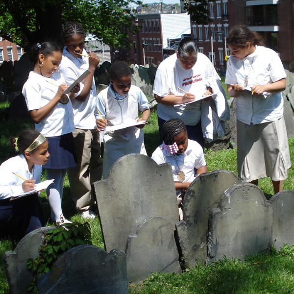 Kids taking notes at Copps' Hill Burying Ground.