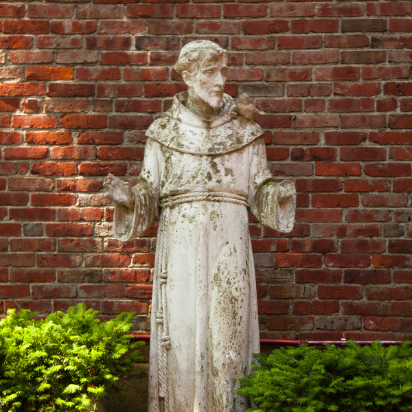 A statue of St. Francis behind Two Lanterns: Gifts at Old North Church.
