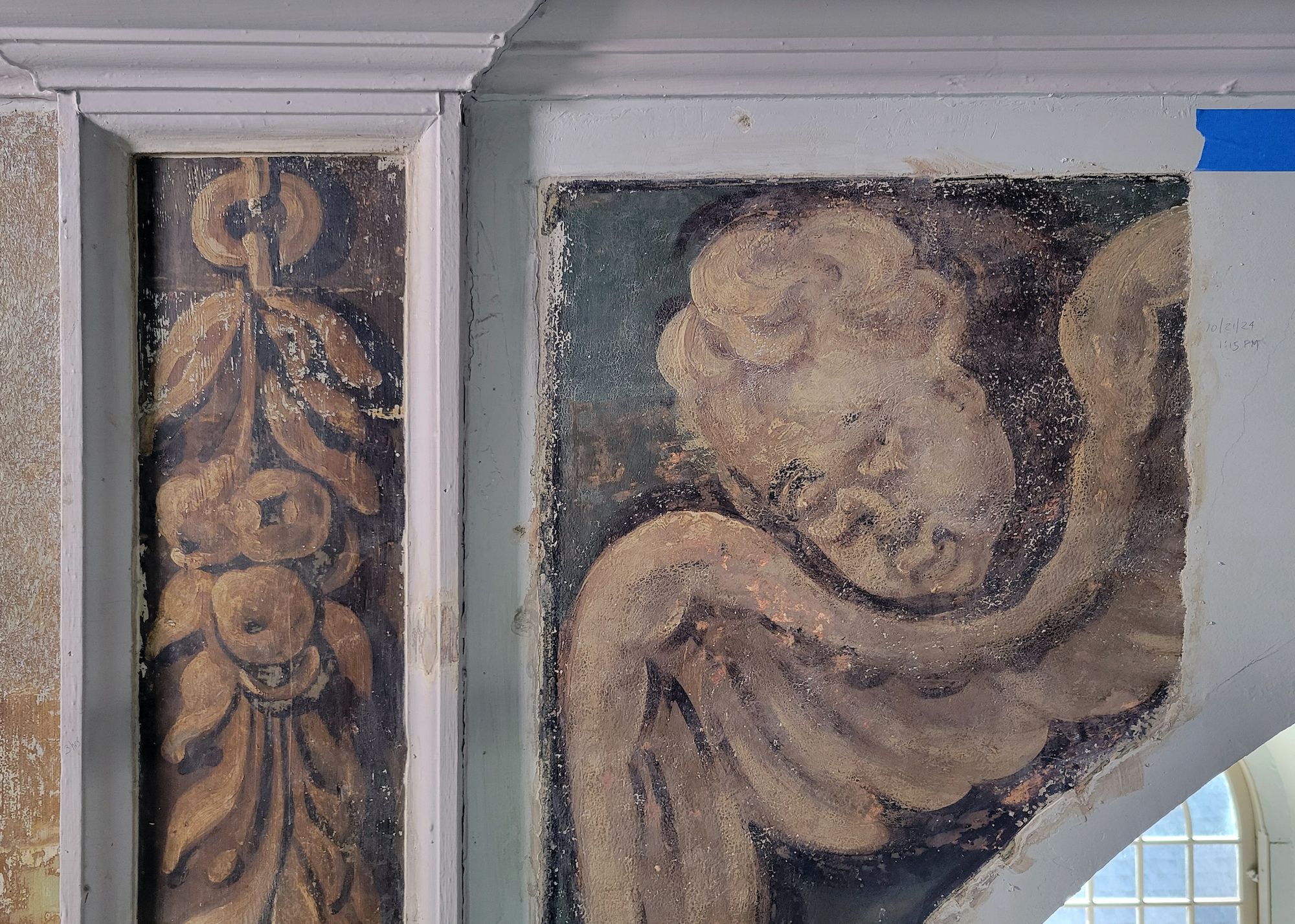 The face of a newly exposed cherub and a festoon at Old North Church.