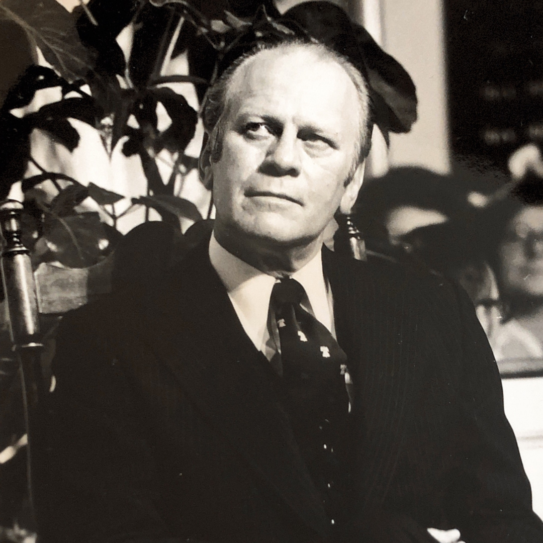 Gerald Ford sitting in a chair at the Old North Church in 1975.