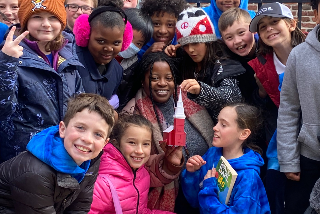 Students and their teacher posing for a photo outside of the Old North Church.