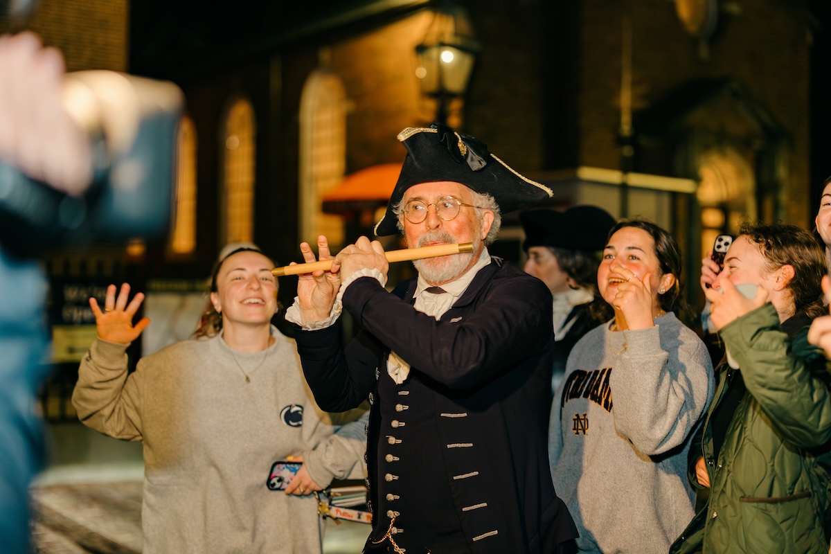 Toddy, an 18th century period musician, playing the flute for a delighted crowd at Old North Church.